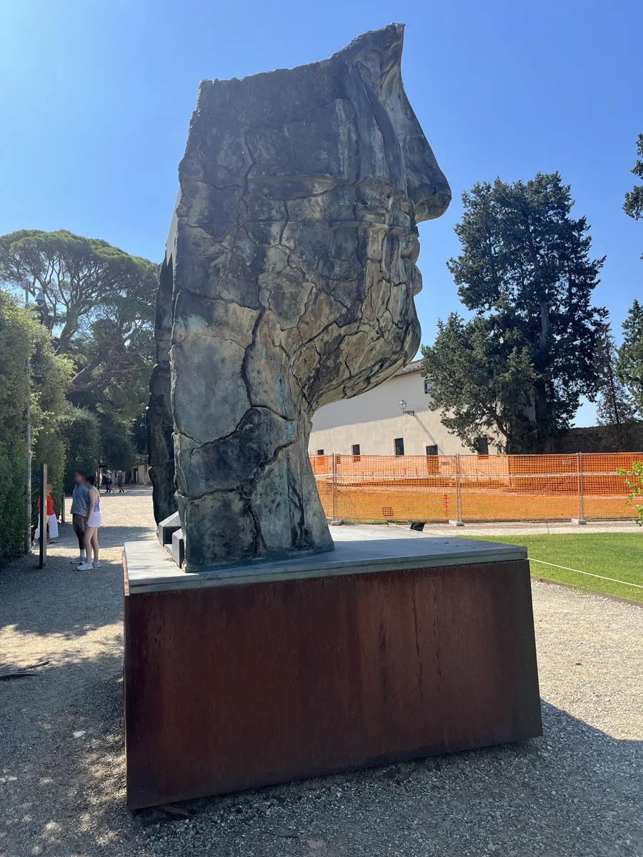 Tindaro Screpolato (1997) by Igor Mitoraj — side view showing the sculpture and its Corten plinth, Boboli Gardens, Florence