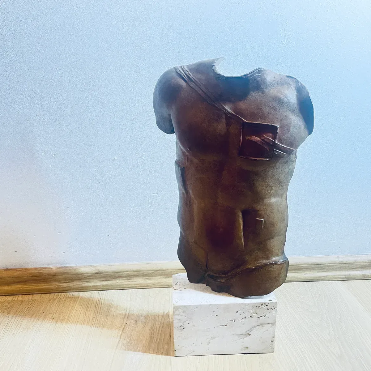 Persée (1988) — Igor Mitoraj, brown patina bronze torso, three-quarter front view, signature visible on lower right, private collection