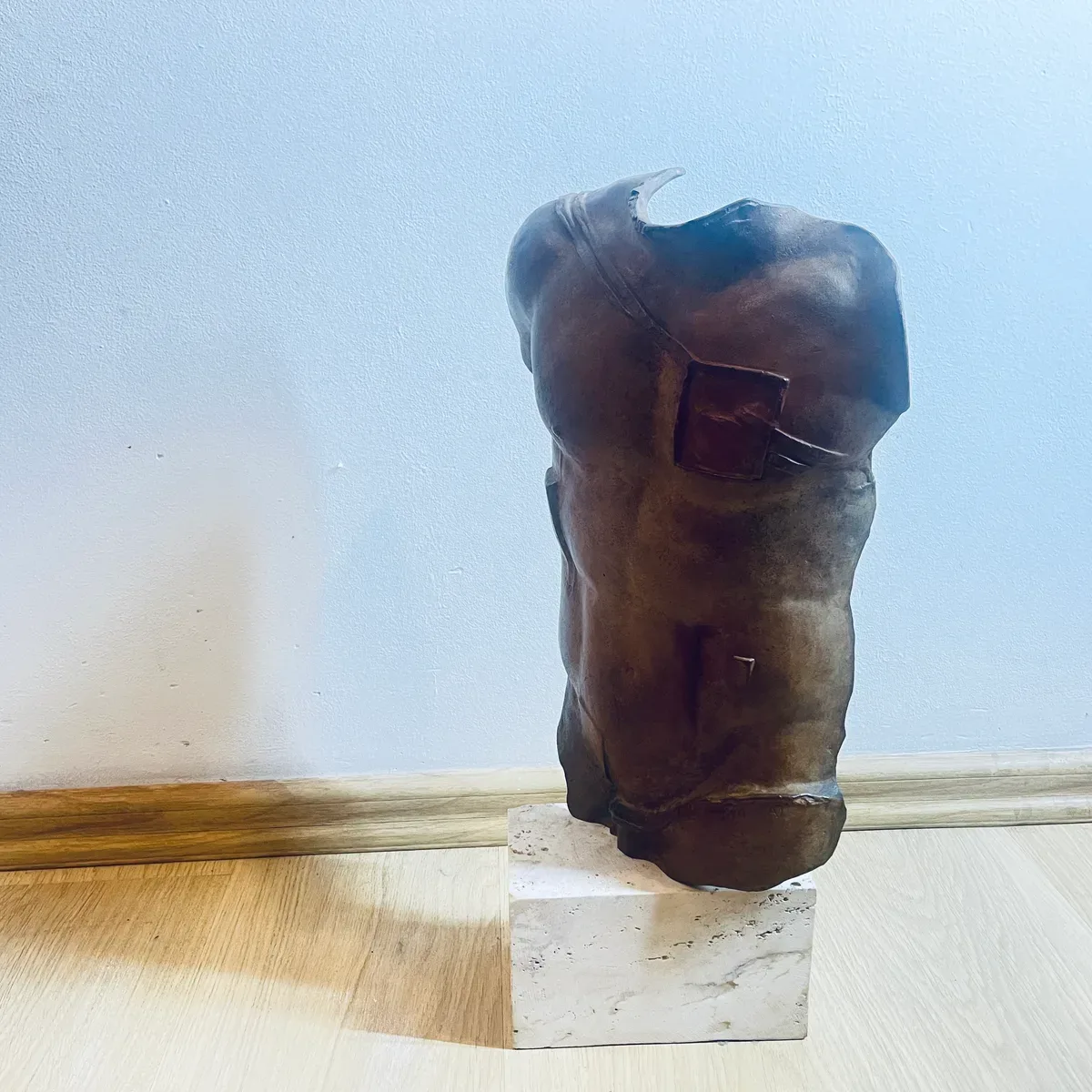 Persée (1988) — Igor Mitoraj, brown patina bronze torso, side view showing profile and pectoral inset, private collection