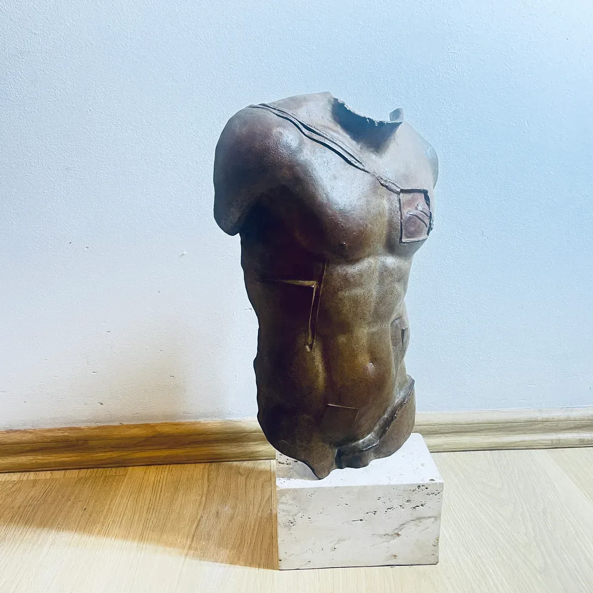 Persée (1988) — Igor Mitoraj, brown patina bronze torso, three-quarter view showing characteristic Mitoraj inset details on chest and abdomen, private collection