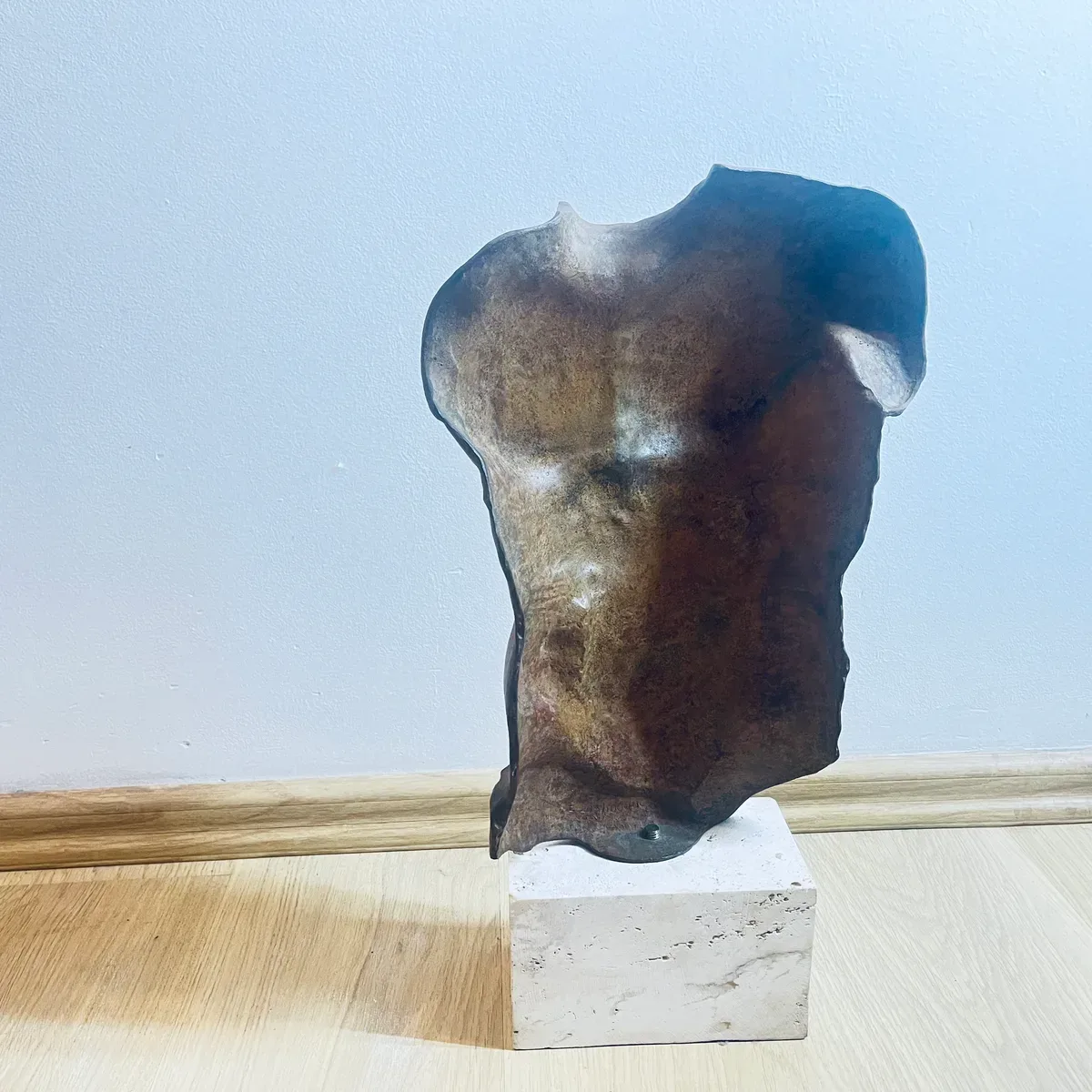 Persée (1988) — Igor Mitoraj, brown patina bronze torso, back view showing smooth dorsal surface and mounting hardware, private collection