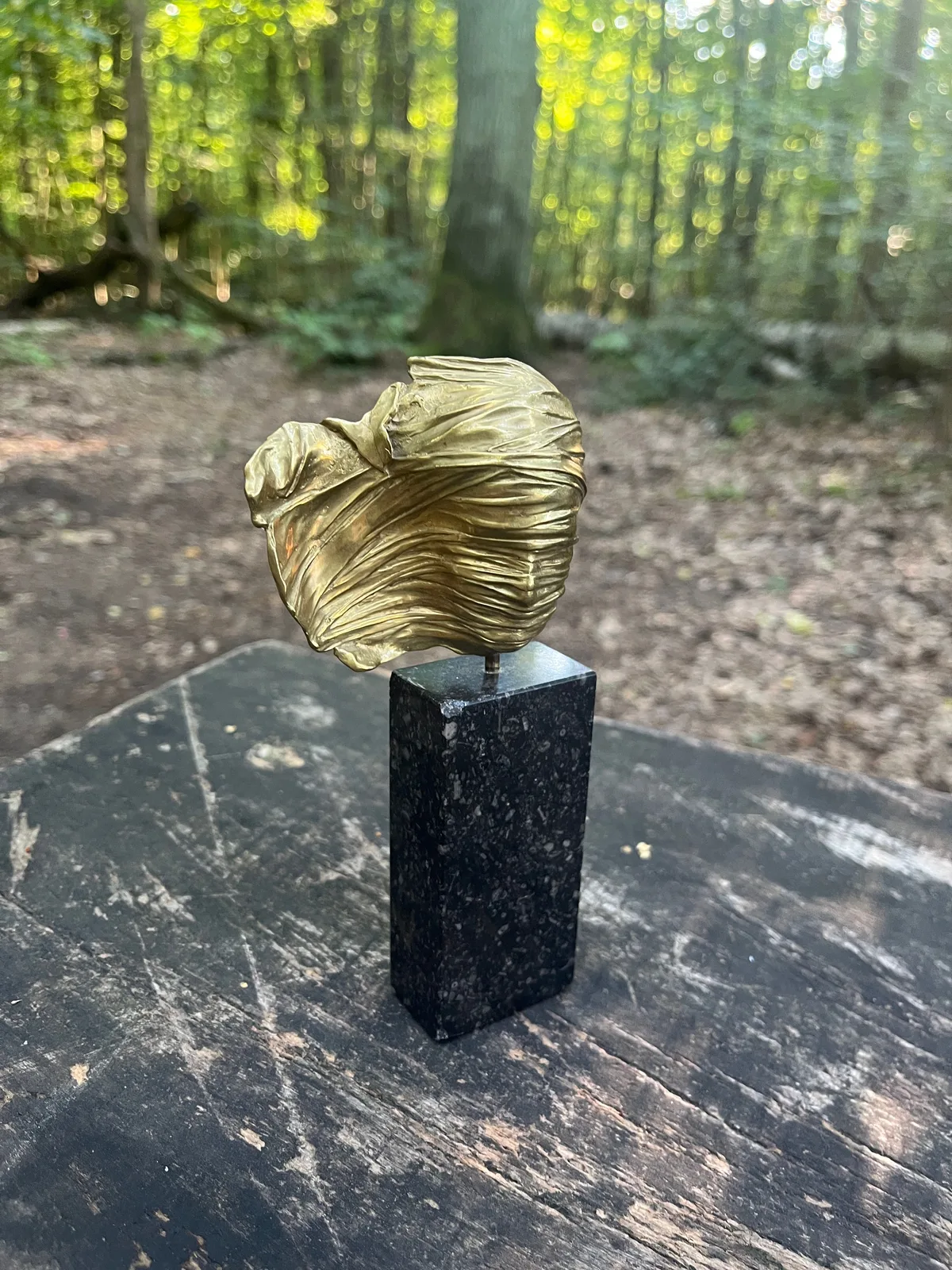 Visage Voilé — Mitoraj bronze, side view showing marble base and floating pin mount