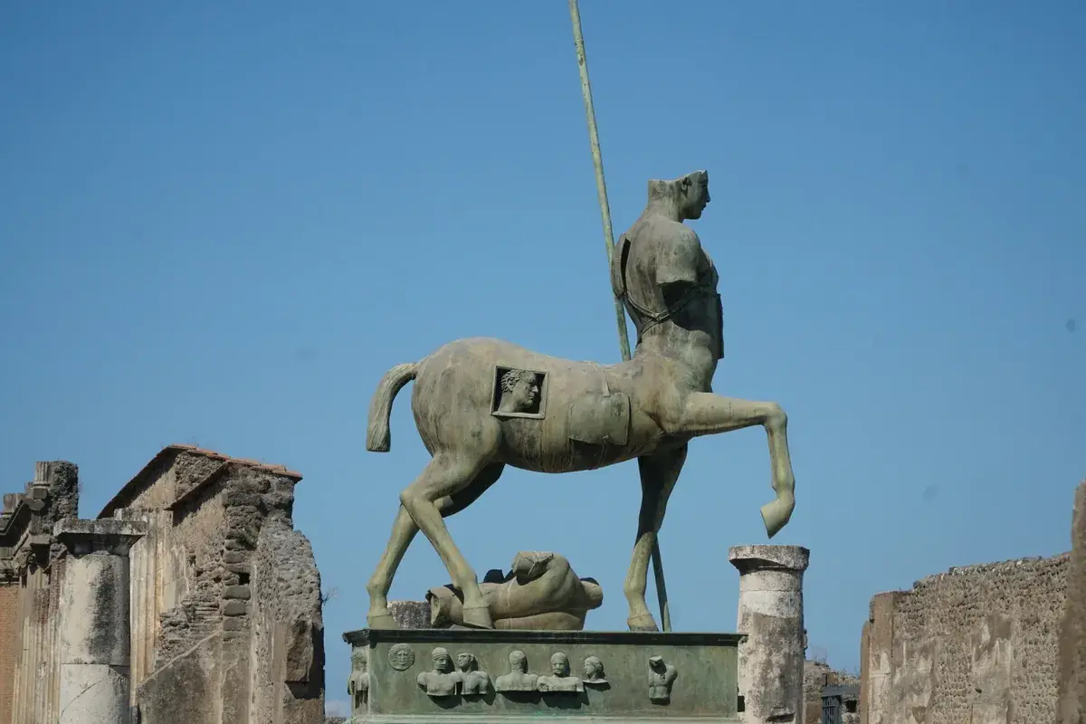 Igor Mitoraj Centauro bronze centaur sculpture among the ruins of Pompeii — permanent public collection